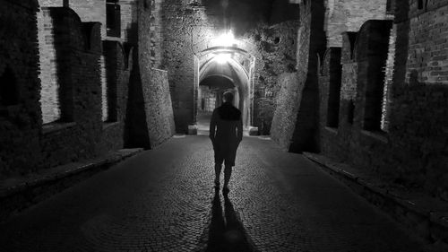 Rear view of man walking on walkway