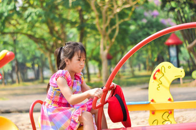Cute little girl having fun on a playground outdoors. summer concept