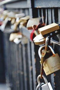 Close-up of padlocks hanging on railing