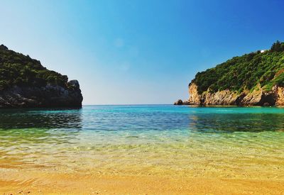 Scenic view of sea against clear blue sky