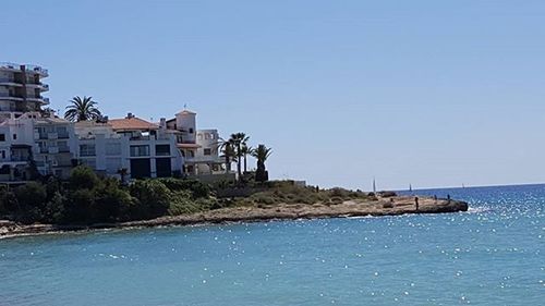 View of sea against clear blue sky