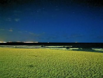 Scenic view of field against sky at night