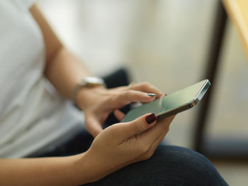 Midsection of man using mobile phone