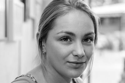 Close-up portrait of smiling young woman