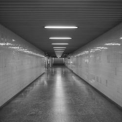 Empty corridor in illuminated building