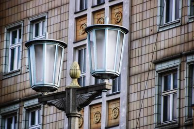 Low angle view of street light against building