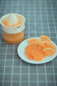 Close-up of orange slice in plate on table