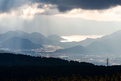 Scenic view of mountains against cloudy sky