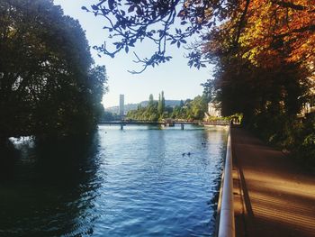 Walkway by river in city