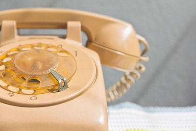 Close-up of rotary telephone on table