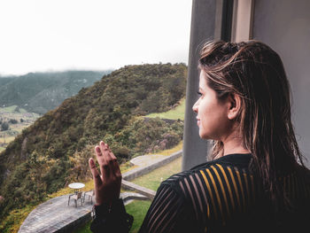 Portrait of young woman looking at mountains