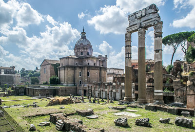 Roman forum ruins and the dome of saints luca and martina church. rome, italy. summer wide angle.