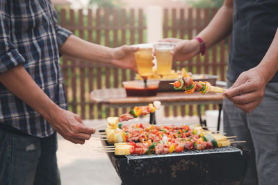 Midsection of people holding food