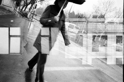 Side view of man running on road in city