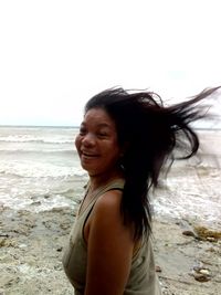 Portrait of smiling young woman on beach