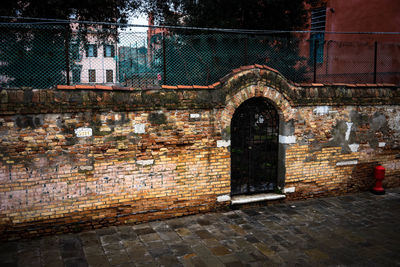 Old wall by building in city