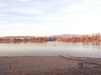 Scenic view of lake against sky during winter