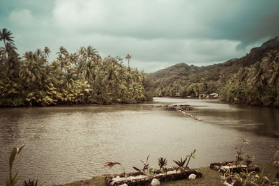 Scenic view of lake against cloudy sky