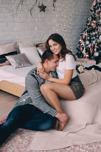 Happy friends sitting on floor