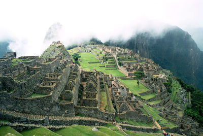 View of old ruins on mountain against sky