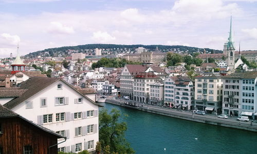 View of cityscape against cloudy sky