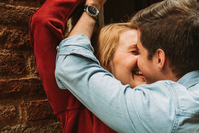 Portrait of young couple kissing outdoors