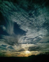 Low angle view of landscape against cloudy sky