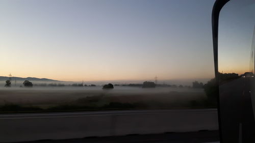 Road against clear sky during sunset