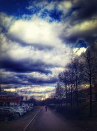 Road against cloudy sky at sunset