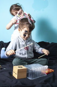 Full length of boy sitting in toy at home