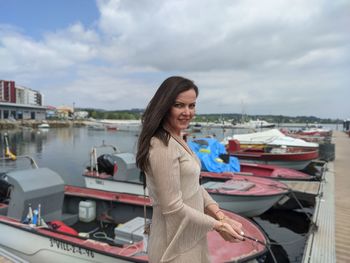 Portrait of young woman sitting on boat in sea