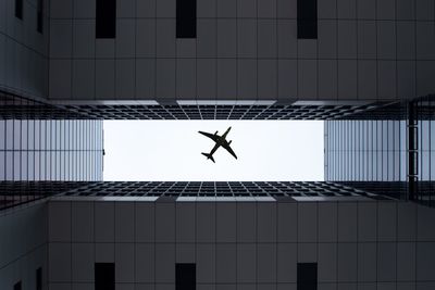 Directly below shot of airplane flying in sky