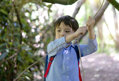 Portrait of boy with arms raised