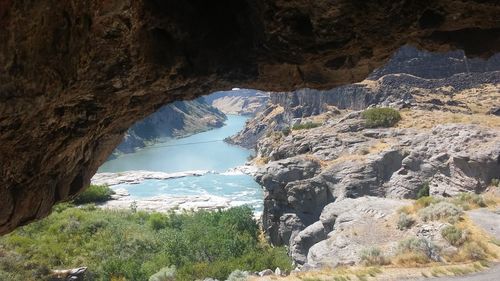 Scenic view of mountains seen through cave