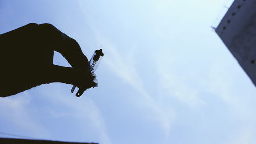 Low angle view of man against blue sky