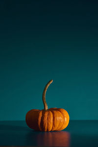 Close-up of pumpkin against blue background