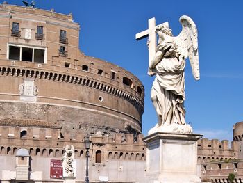 Low angle view of statue against clear blue sky