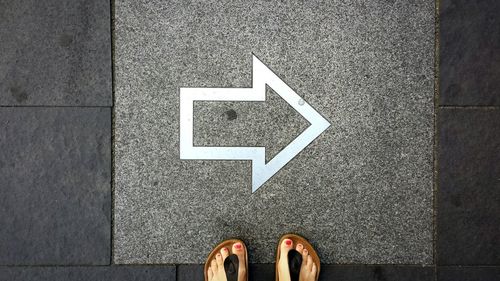 High angle view of an arrow on sidewalk