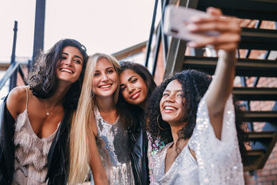 Portrait of smiling young woman using mobile phone