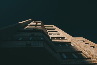 Low angle view of building against clear sky at night