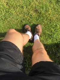 Low section of man and woman standing on grass