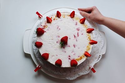 Cropped image of hand holding cake