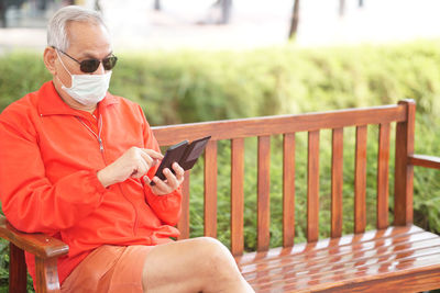 Man using smart phone on railing