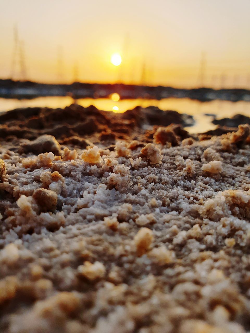 SURFACE LEVEL OF ROCKS AT BEACH DURING SUNSET