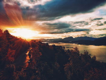 Scenic view of dramatic sky over mountains during sunset