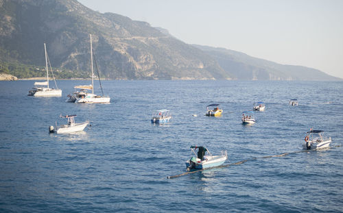 Sailboats in sea against sky