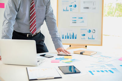 Low angle view of man using laptop on table