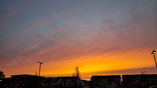 Low angle view of silhouette buildings against sky during sunset