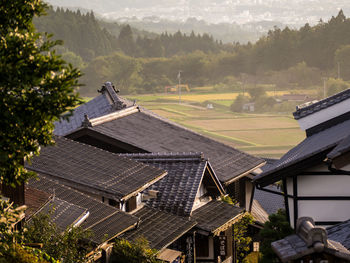 High angle view of houses and trees on landscape