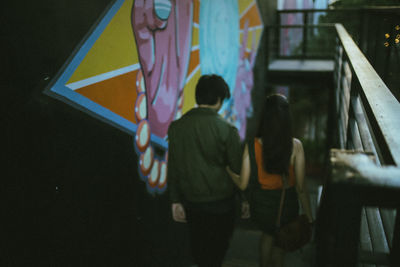 High angle view of couple moving down on steps